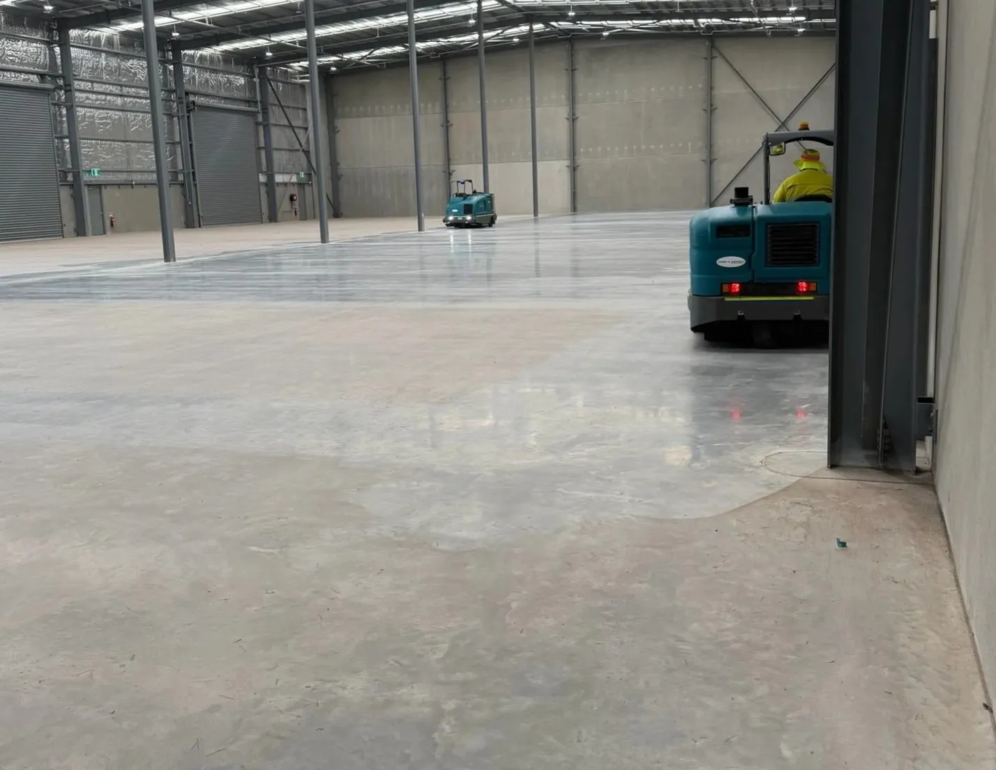 Fine concrete dust on a warehouse floor in Wangara, Perth before treatment